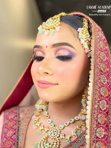 This bridal look features a beautiful blend of purple and gold on the eyes, paired with a soft pink lip. Our students learn to create balanced and harmonious color palettes for any bridal outfit.