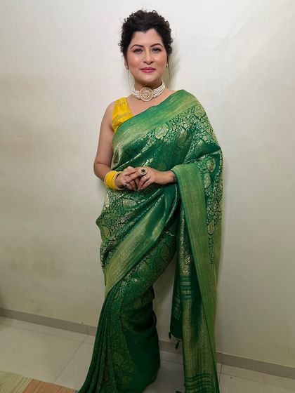 A confident pose on the red carpet. The entire look, from the saree draping to the makeup and hair, comes together perfectly for a glamorous event.