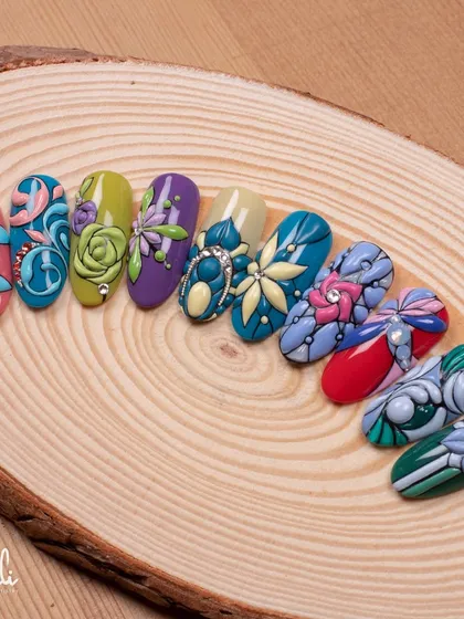 I love working with textures. Here, I've used my emboss gel technique to create raised floral and bow designs, each with its own unique pattern and color story, displayed on a natural wood slice.
