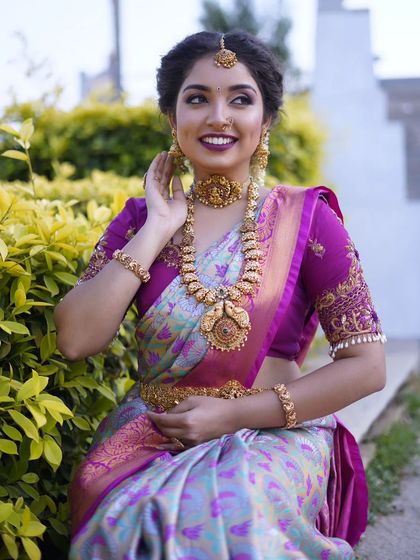 A beautiful shot of a model wearing our antique temple jewellery set. The smile on her face shows how confident and beautiful our jewellery can make you feel.