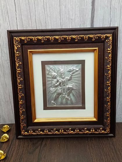 A powerful 999 pure silver frame of Lord Hanuman carrying the Sanjeevani mountain, a symbol of strength and devotion.