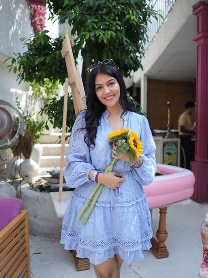 A full shot of the blue dress. The delicate embroidery and tiered design make it a sweet and feminine choice for everyday wear.