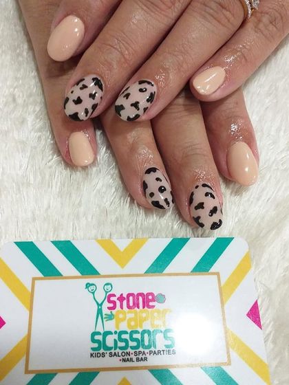A chic and simple animal print design. I painted a classic leopard spot pattern on a few accent nails and kept the rest a solid nude color for a balanced, stylish manicure.