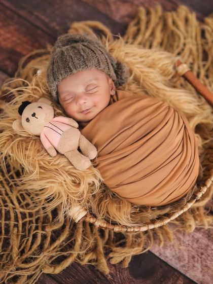 Cuddled up with a tiny teddy bear. Using props like this can show just how small your newborn is. So cute and little.