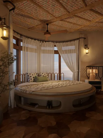 In this suite, a custom circular bed becomes the centerpiece, echoing the curved architecture of the room. Sheer curtains diffuse the natural light from the large windows, creating a soft, dreamy atmosphere perfect for a restful escape.
