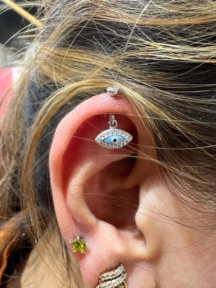 The same evil eye hanging, a customer favorite for its protective symbolism and sparkling design.