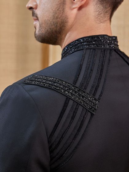 A view of the back and shoulder detailing on the embroidered achkan. The craftsmanship is consistent from every angle, ensuring a complete and luxurious piece.