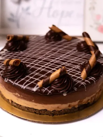 Our Chocolate Mousse Roll Cake is light yet indulgent. A creamy chocolate mousse is layered with cake and topped with chocolate curls and wafer rolls.