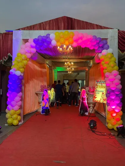 The entrance to the Disney Princess party, featuring a red carpet and a colorful balloon arch to welcome the guests.