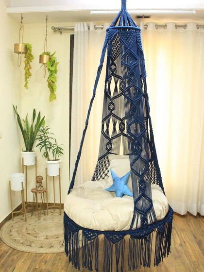 A single seater jhula in a deep navy blue. The design is perfect for brightening up your home, and as the manufacturer, we offer it at half the price.