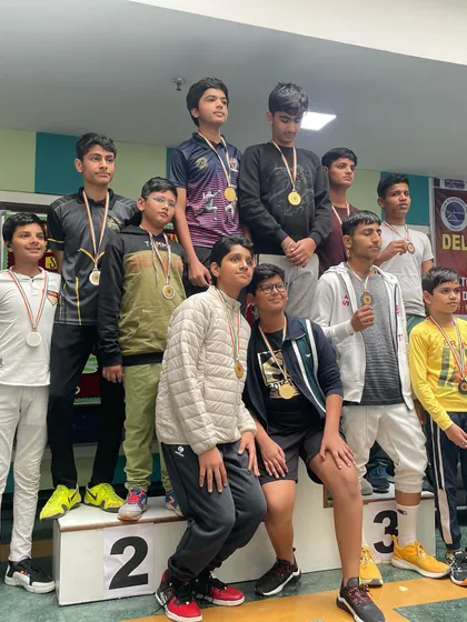 Our young fencers crowding the podium at the state championship. This picture captures the excitement and camaraderie of winning.