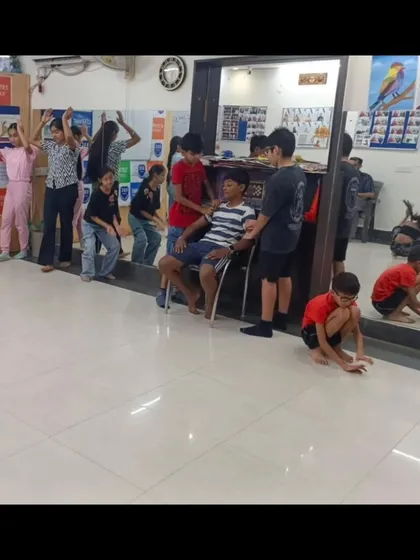 Students participating in a physical theatre exercise. These activities help them understand how to use their bodies to tell stories and express emotions, a key component of our drama curriculum.