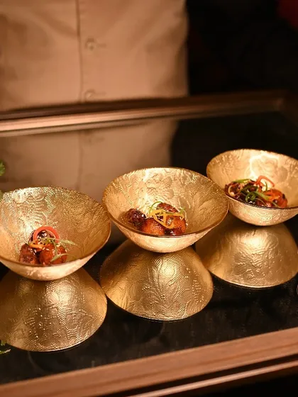 Asian-style cottage cheese served in stunning gold-leafed bowls, part of the pass-around appetizer service.