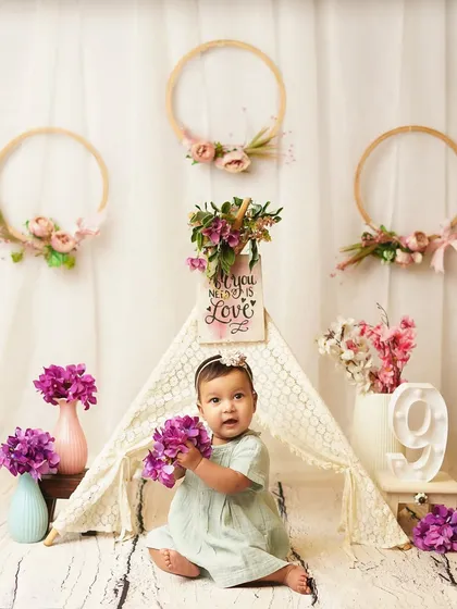 This little explorer is captivated by the flowers. I use safe, age-appropriate props to engage babies and bring out their natural curiosity.