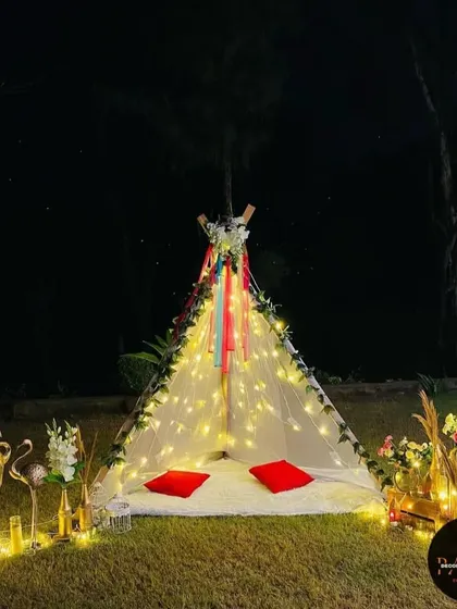 I also create intimate and romantic settings like this cozy canopy tent. Decorated with fairy lights, flowers, and comfortable seating, it's the perfect private space for a couple to celebrate an anniversary or a quiet proposal.