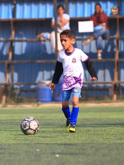 A young player looking for a pass, demonstrating the vision and awareness we teach from an early age.