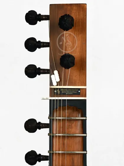 The headstock of our Zen+ model sitar. This is a more modern, minimalist design, focusing on clean lines and functionality with traditional pegs.