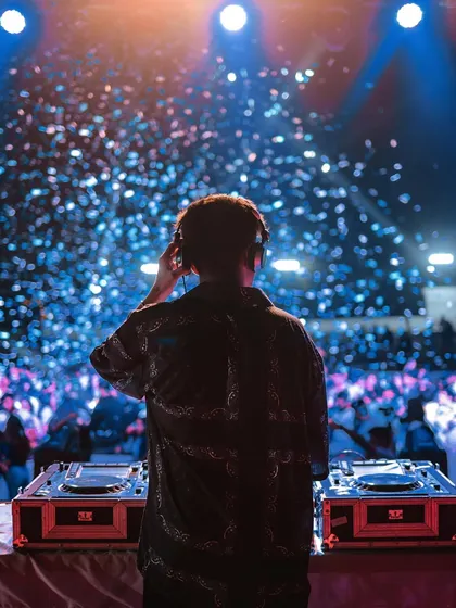 There's no feeling like looking out at a sea of people, all connected by the music. This shot, with the confetti falling, captures that peak moment of pure joy and energy that I strive to create at every large-scale event and college festival.