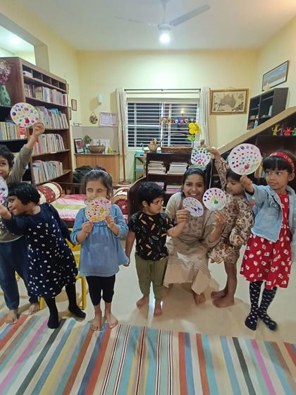 Another happy group poses with their "Magic Shoes" crafts, celebrating their creativity.