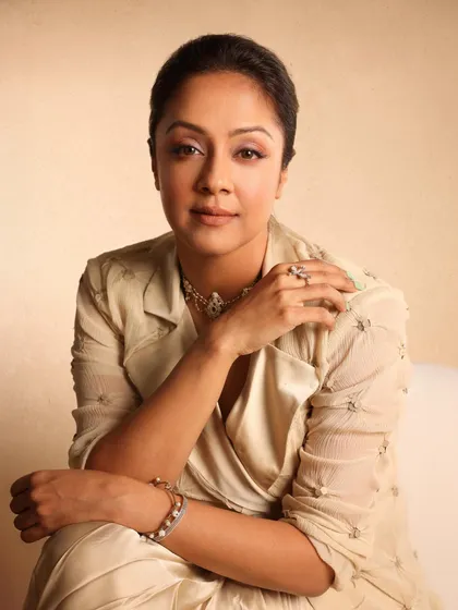 Jyotika looking radiant in a golden draped dress by Anamika Khanna, a look that is both modern and timelessly elegant.