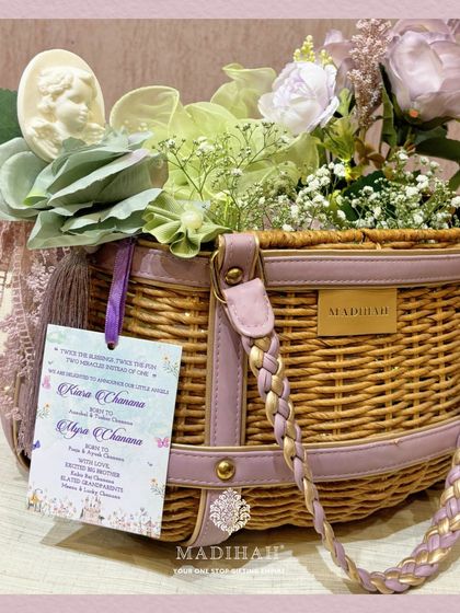 This view of the Cane Arrival Basket shows the personalized tag for twins, 'Kiara & Myra'. It demonstrates how I customize each hamper to perfectly suit your family's unique and joyous occasion.