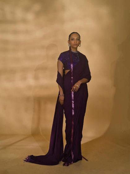 A full-length shot of a model in a modern purple saree from the Nikhil Thampi campaign.