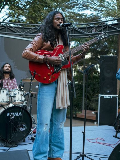 The lead singer and guitarist captivates the audience at the World Food Carnival. We ensure our festivals feature talented artists to create an unforgettable vibe.