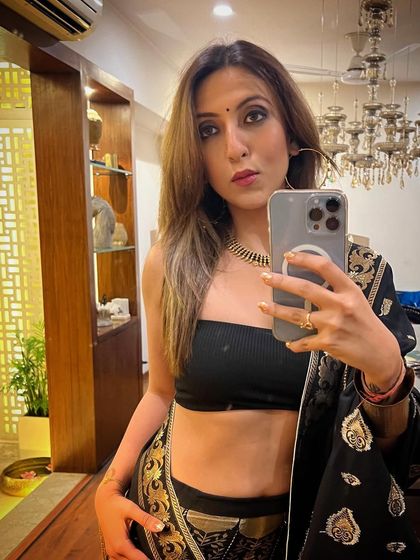 A festive look featuring a black and gold saree paired with a simple black bandeau top for a modern twist.