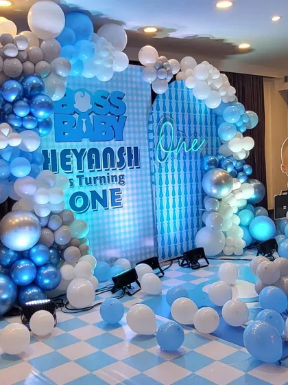 A view of the Boss Baby stage with its checkered floor and extensive balloon decorations, creating an immersive and fun atmosphere for the party.