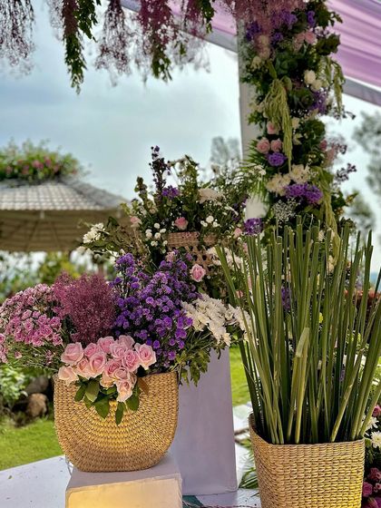 More details of the soothing lilac and lavender decor, with fresh flowers arranged in rustic woven baskets.