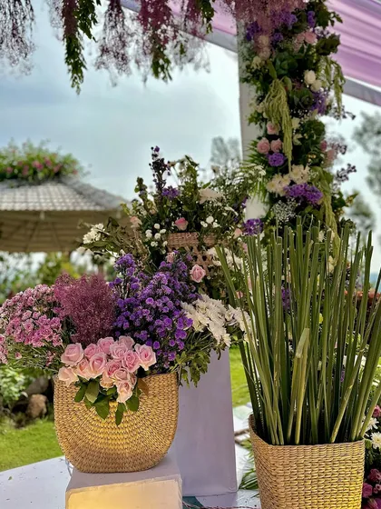 More details of the soothing lilac and lavender decor, with fresh flowers arranged in rustic woven baskets.