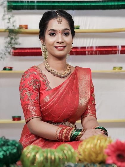 A classic South Indian hairstyle with a simple bun and jasmine flowers.