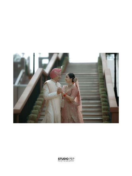 A low-angle shot of the couple on the staircase, creating a sense of grandeur and romance.