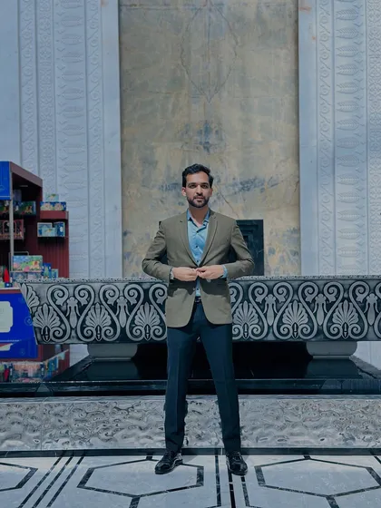 A full-length shot showing my business casual attire. I pay attention to detail, from the fit of the jacket to the shine of my shoes, because presentation matters.