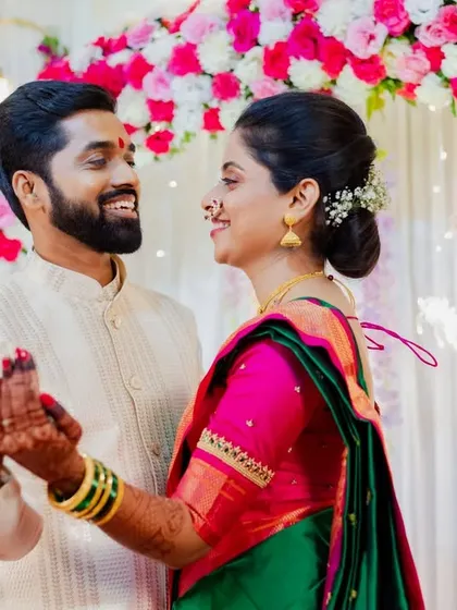 A candid dance moment between Asawari and Amit, surrounded by beautiful floral decorations. Capturing movement and joy is key to lively event photography.