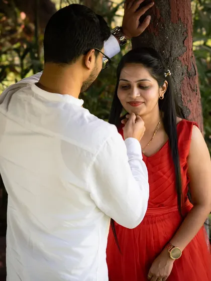 A tender close up moment where he gently touches her chin. This intimate gesture, captured during their post-wedding session, highlights their deep connection.