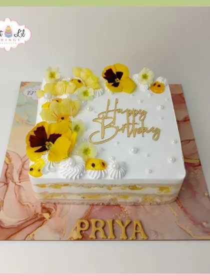 A sunny and cheerful birthday cake for Priya. This square cake is topped with beautiful fresh yellow pansies and other edible flowers.
