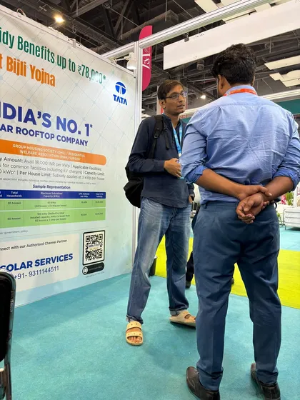 A member of our team explains the PM Surya Ghar Muft Bijli Yojana to an interested visitor at a solar expo. We provide complete solar subsidy assistance to make the switch to solar more affordable for you.