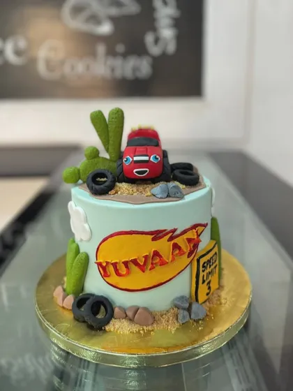 Here's a fun cake based on the popular show Blaze and the Monster Machines. We used fondant to create the character and desert-themed elements like cacti and tires.