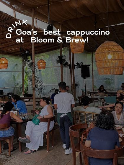 This image captures the ambiance of a bustling cafe in Goa. The text overlay "DRINK Goa's best cappuccino at Bloom & Brew!" turns a simple ambiance shot into a direct call to action.