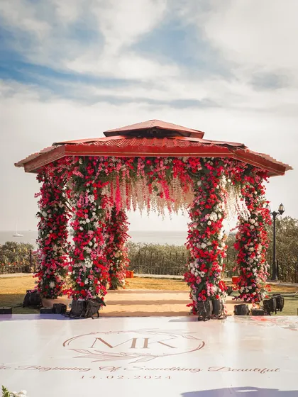 For couples who dream of a seaside ceremony, I design mandaps that blend romance with the natural beauty of the location. This stunning floral mandap, overflowing with red and white blooms, created an unforgettable setting for vows exchanged against the ocean backdrop.