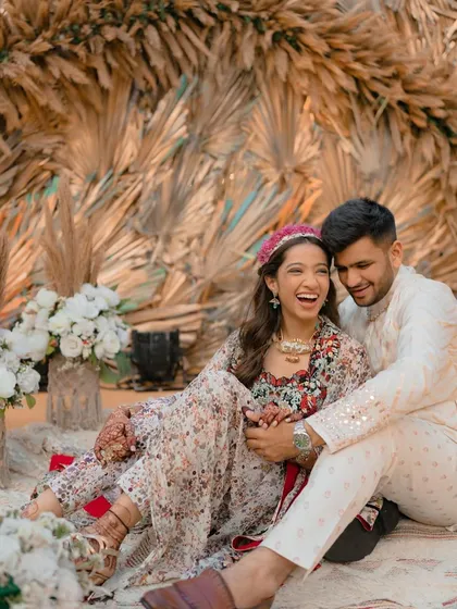 A happy bride at her carnival-themed event, with her hair in soft waves and a cute floral headband.