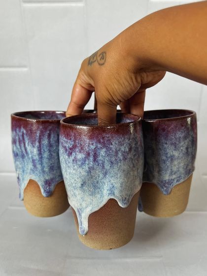 These grip tumblers are designed with an indent for your fingers, making them incredibly comfortable to hold. Here I am holding three of them to show how they fit together.