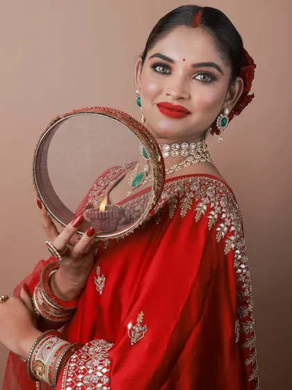 A portrait of the model with the Karva Chauth sieve.