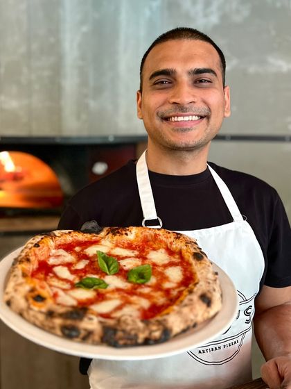 Me, proudly presenting a classic Margherita. This is the result of years of passion and dedication to the craft.