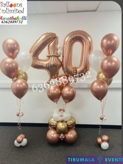 A chic and elegant bouquet for a 40th birthday. This standing arrangement features large rose gold '40' number foils, personalized with the name 'Vicky', and flanked by matching helium balloon bunches.