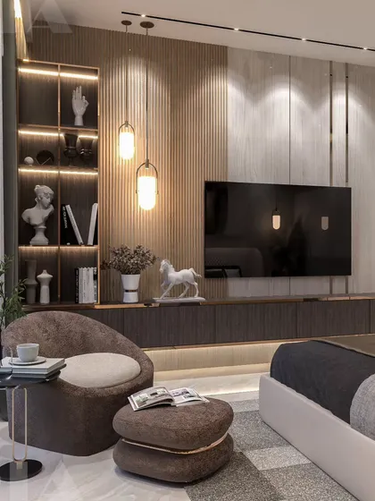 This bedroom design features a full wall of fluted paneling that incorporates the TV unit and backlit display shelves. The combination of textures and integrated lighting creates a cozy yet sophisticated reading nook and media area.