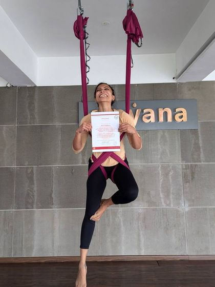 A joyful graduate strikes a pose, certificate in hand, celebrating the end of a transformative training journey.