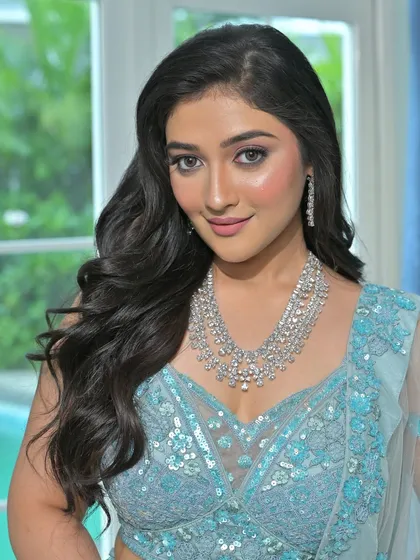 This model looks radiant in a layered zircon necklace. The intricate design and brilliant sparkle make it a perfect choice for any bride who wants a modern yet timeless look.