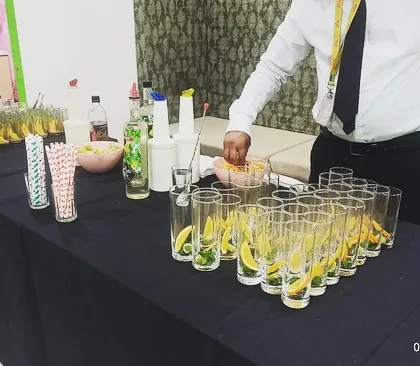 My professional bartenders setting up a mocktail station. They come prepared with all the fresh ingredients and syrups to craft a variety of delicious and refreshing beverages for your guests.